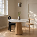 Load image into Gallery viewer, Modern Round Dining Table with Walnut Veneer Top &amp; Travertine-Inspired Pedestal Base
