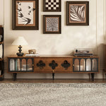 Load image into Gallery viewer, Wooden entertainment console with decorative items in a living room setting
