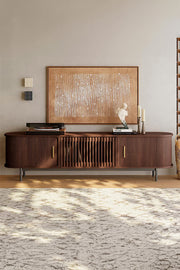 Freestanding TV stand with slatted wood front and elevated legs